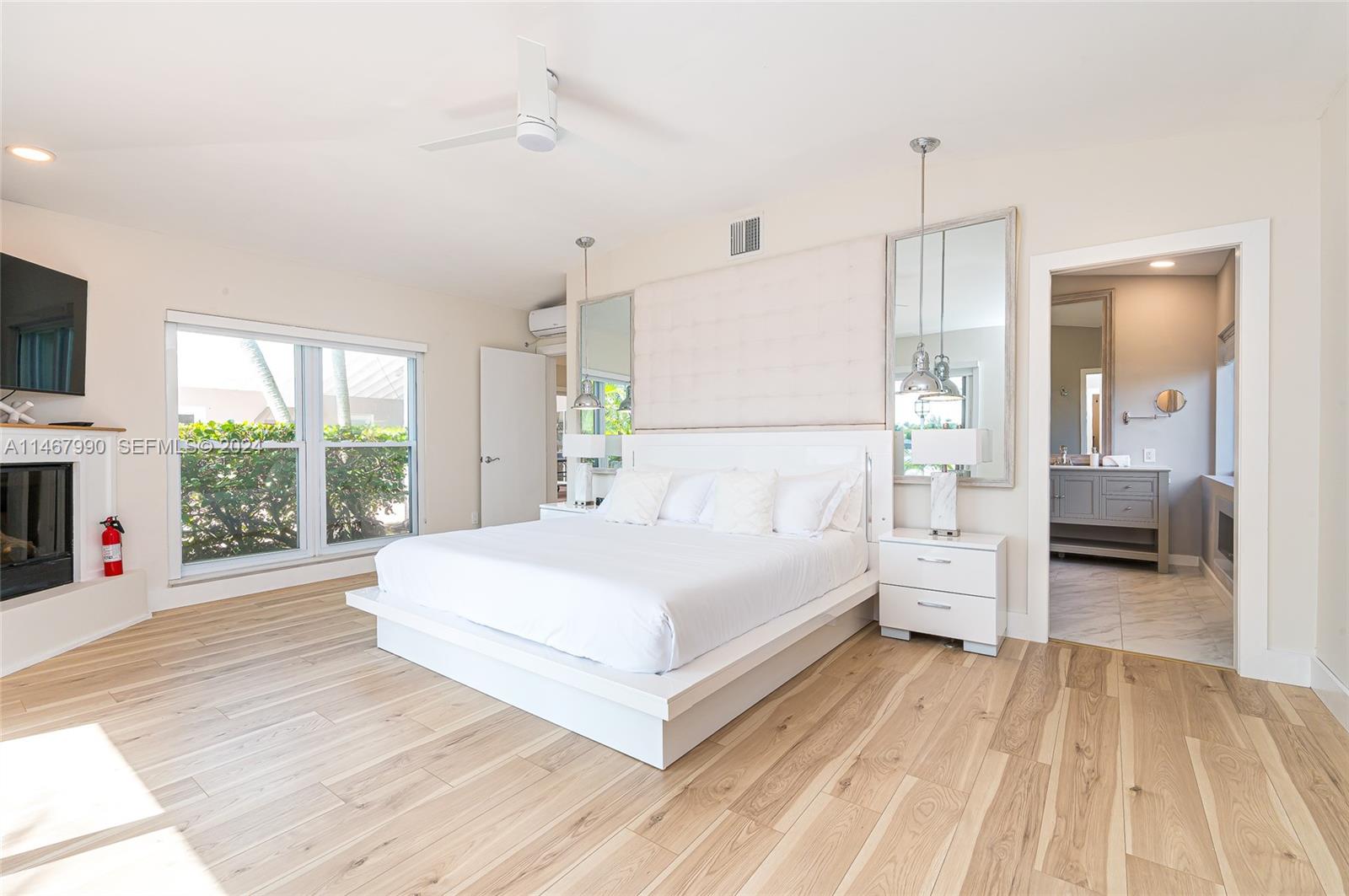 2500 Northeast 199th Street Miami, FL 33180 - Photo 25 of 72 a spacious bedroom with a bed and a large window