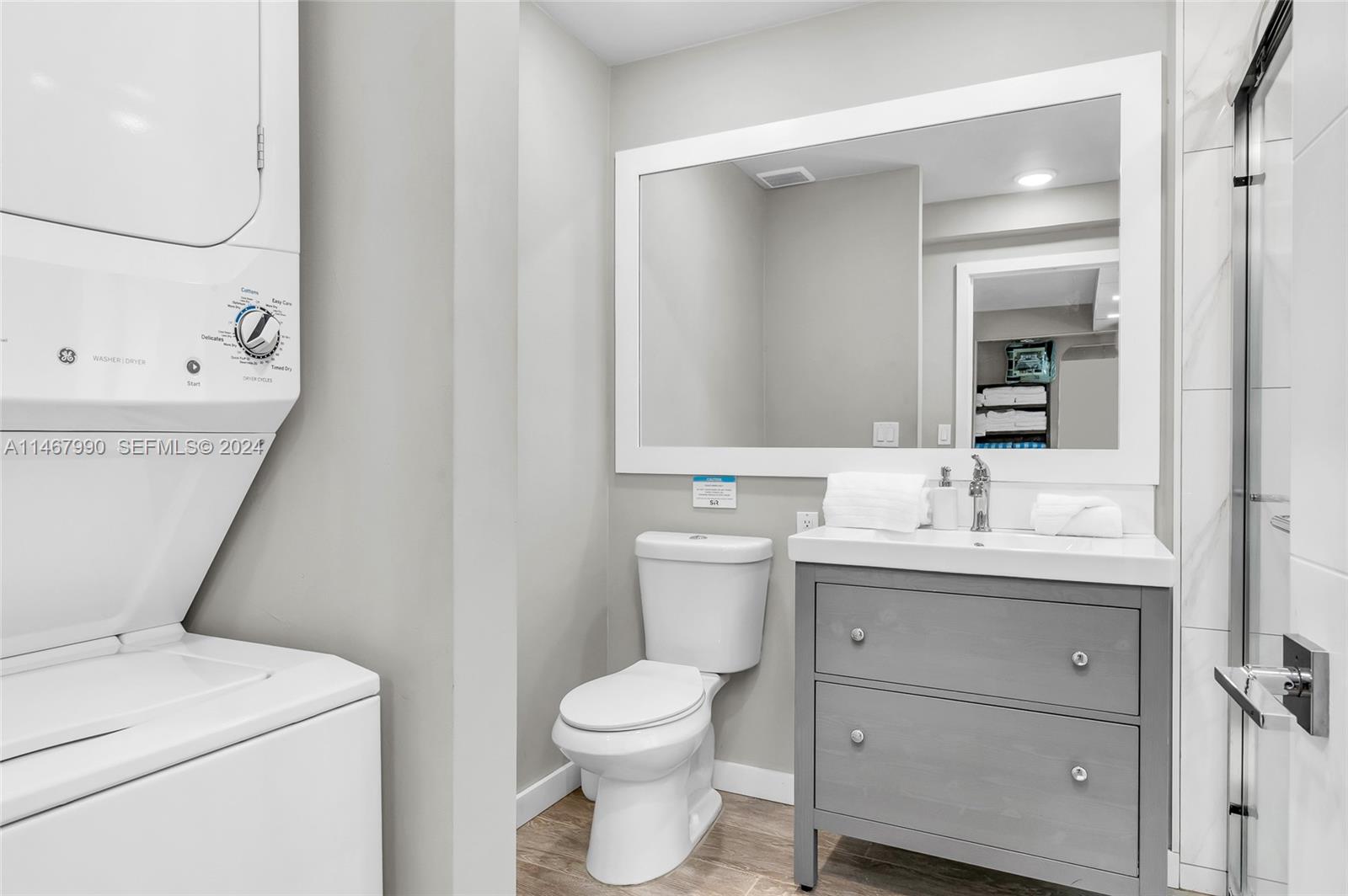 2500 Northeast 199th Street Miami, FL 33180 - Photo 36 of 72 a bathroom with a toilet sink and mirror