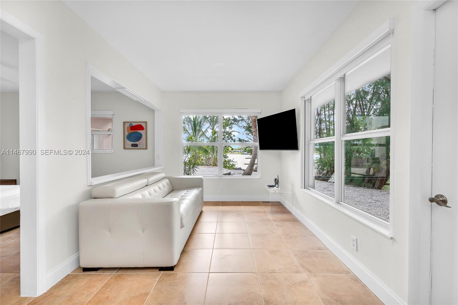 2500 Northeast 199th Street Miami, FL 33180 - Photo 40 of 72 a living room with furniture and a flat screen tv