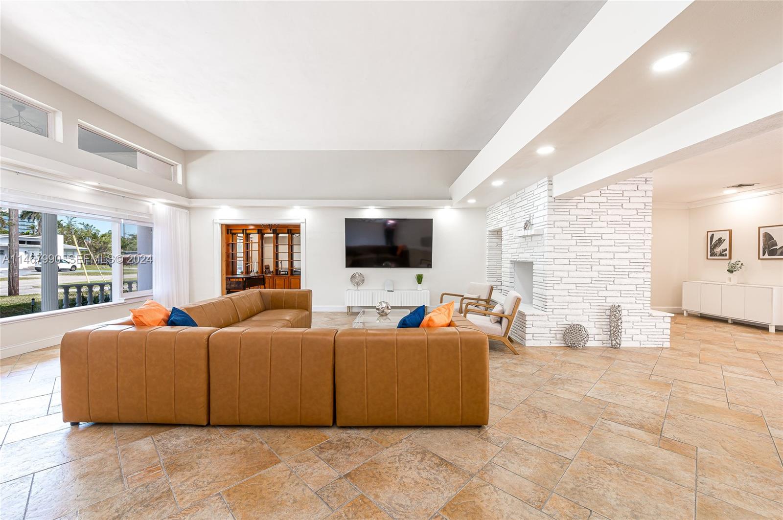 2500 Northeast 199th Street Miami, FL 33180 - Photo 4 of 72 a living room with couches and a flat screen tv