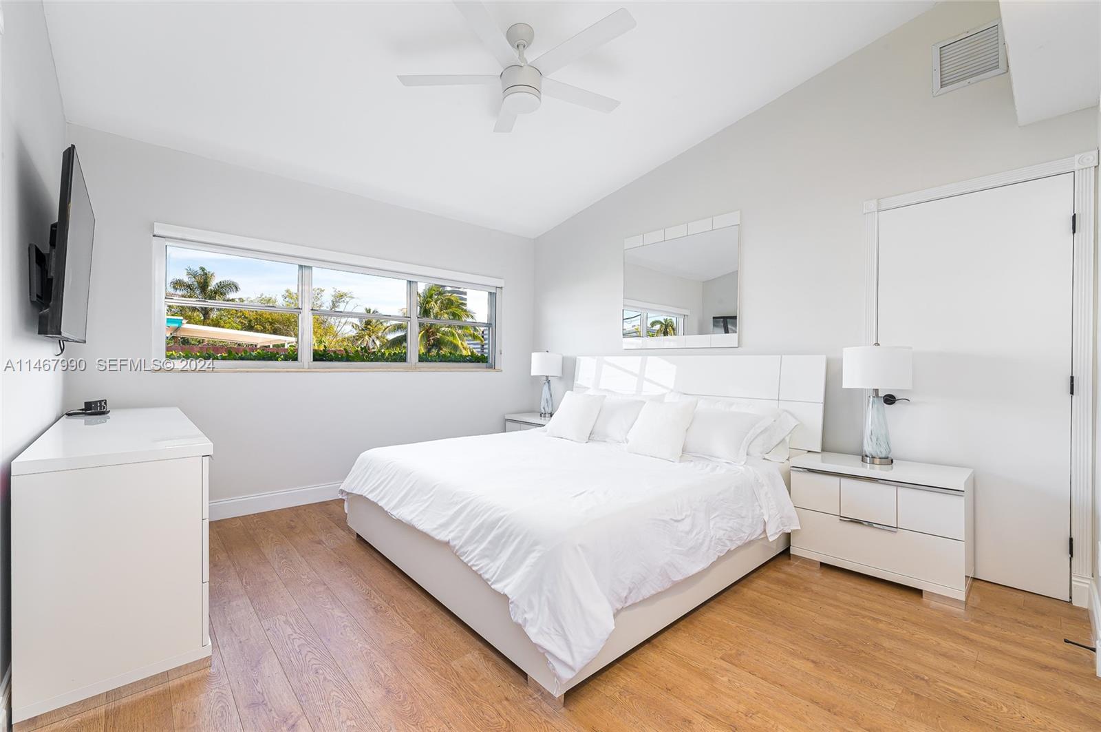 2500 Northeast 199th Street Miami, FL 33180 - Photo 42 of 72 a bedroom with a bed and a flat screen tv