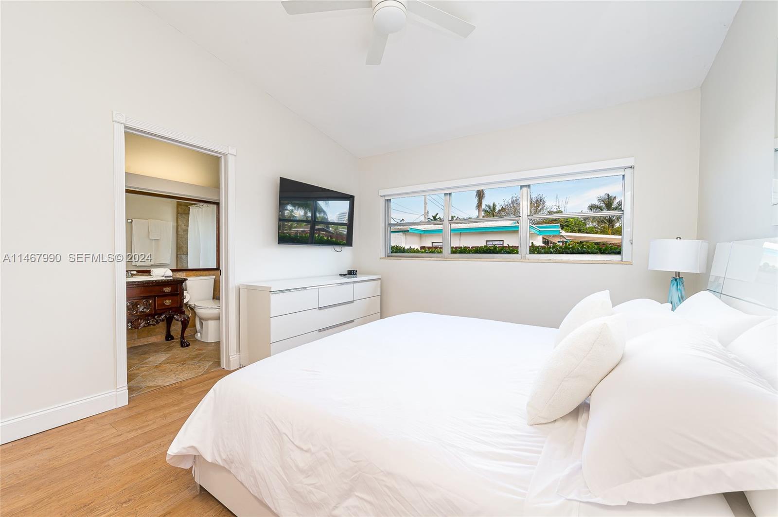 2500 Northeast 199th Street Miami, FL 33180 - Photo 43 of 72 a bedroom with a bed and a flat screen tv