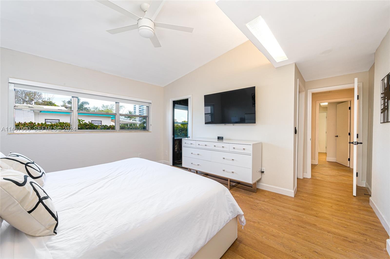 2500 Northeast 199th Street Miami, FL 33180 - Photo 46 of 72 a bedroom with a bed and flat tv screen on the dresser