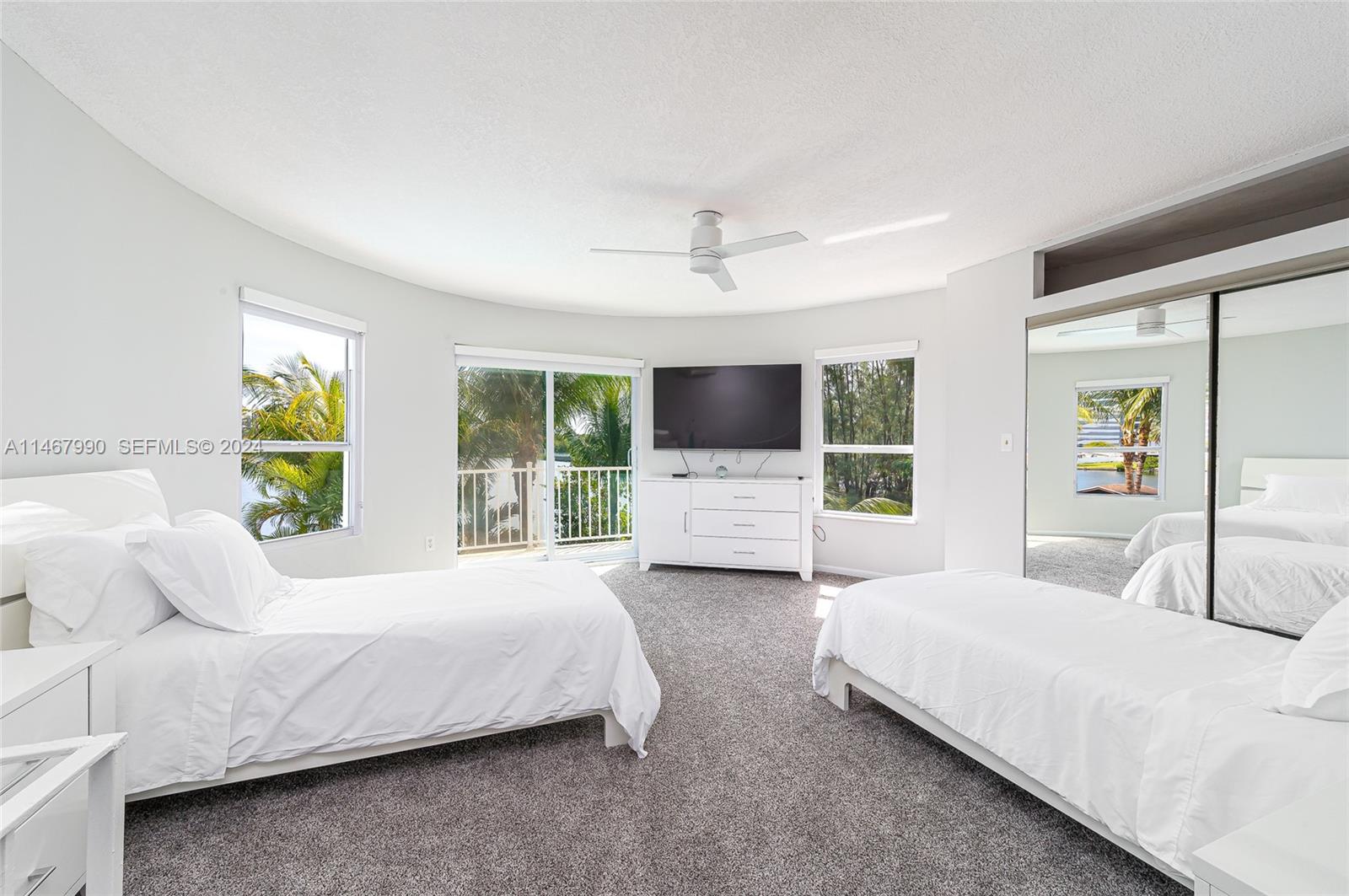 2500 Northeast 199th Street Miami, FL 33180 - Photo 48 of 72 a spacious bedroom with a bed and window