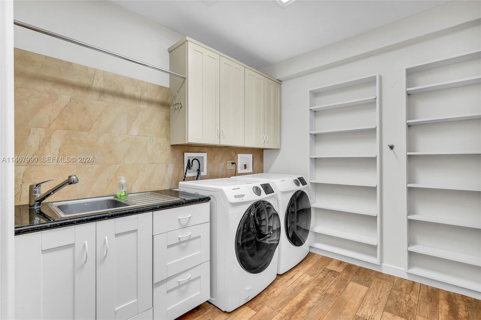 2500 Northeast 199th Street Miami, FL 33180 - Photo 51 of 72 a utility room with sink dryer and washer
