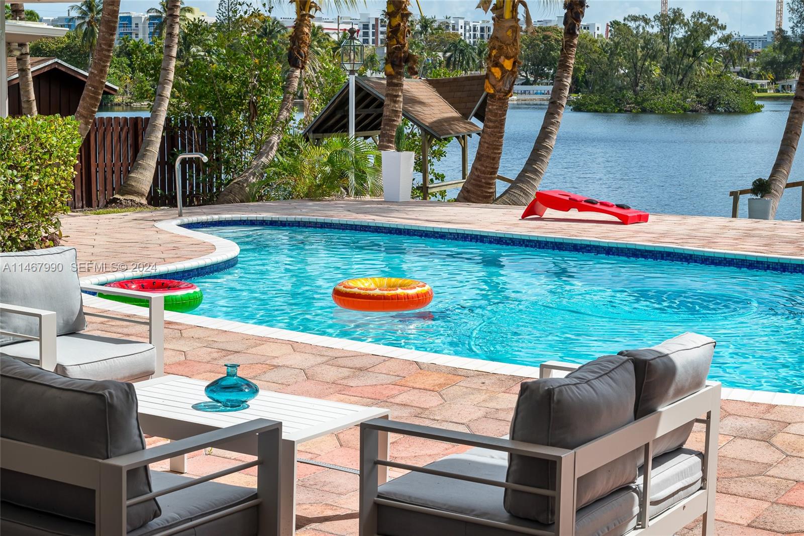 2500 Northeast 199th Street Miami, FL 33180 - Photo 60 of 72 an outdoor sitting area with an umbrella