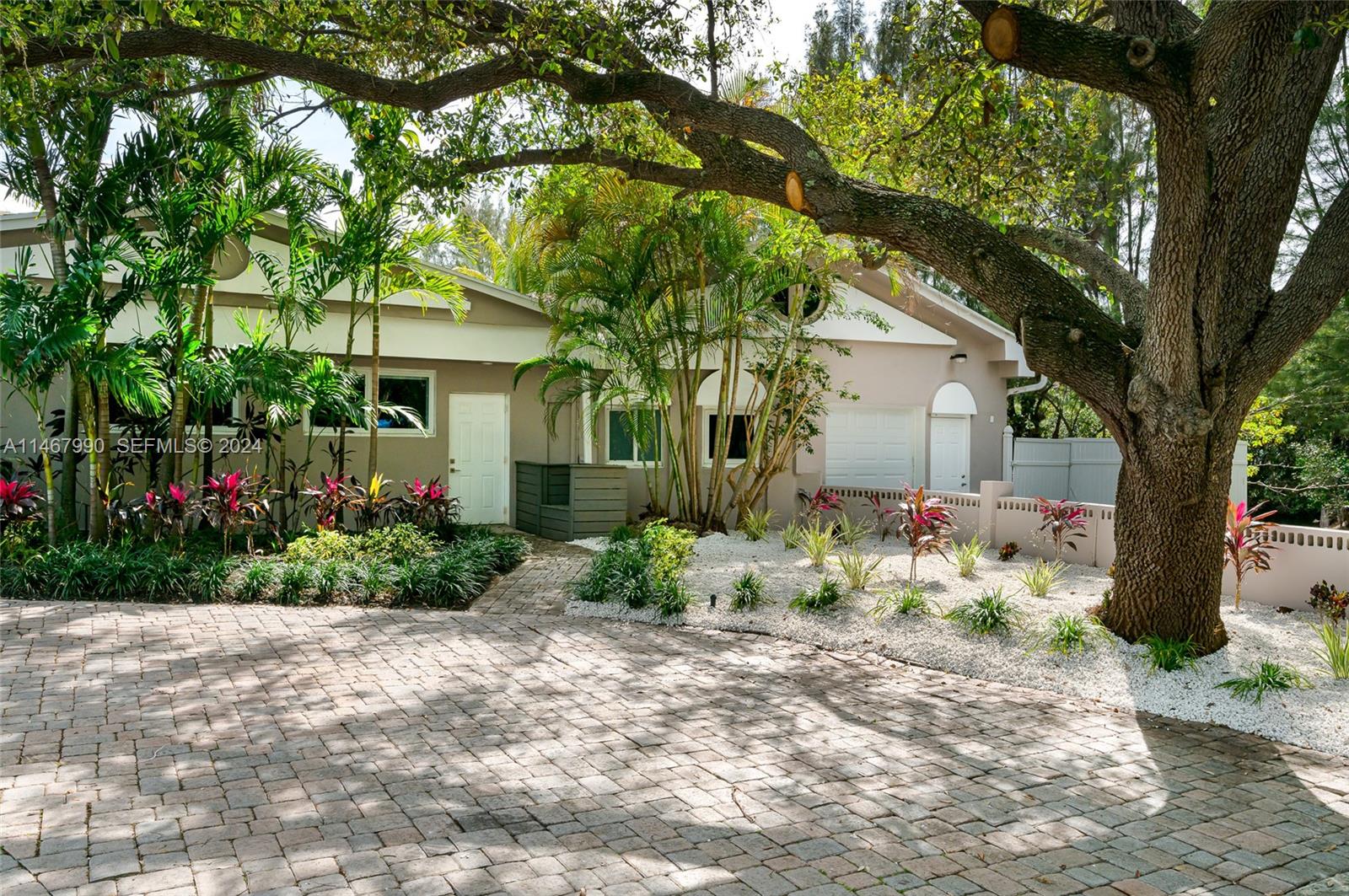 2500 Northeast 199th Street Miami, FL 33180 - Photo 66 of 72 a front view of a house with garden