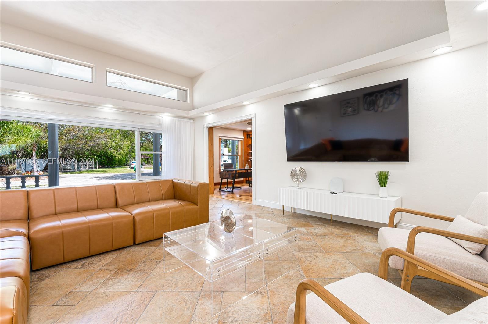2500 Northeast 199th Street Miami, FL 33180 - Photo 8 of 72 a living room with furniture and a flat screen tv