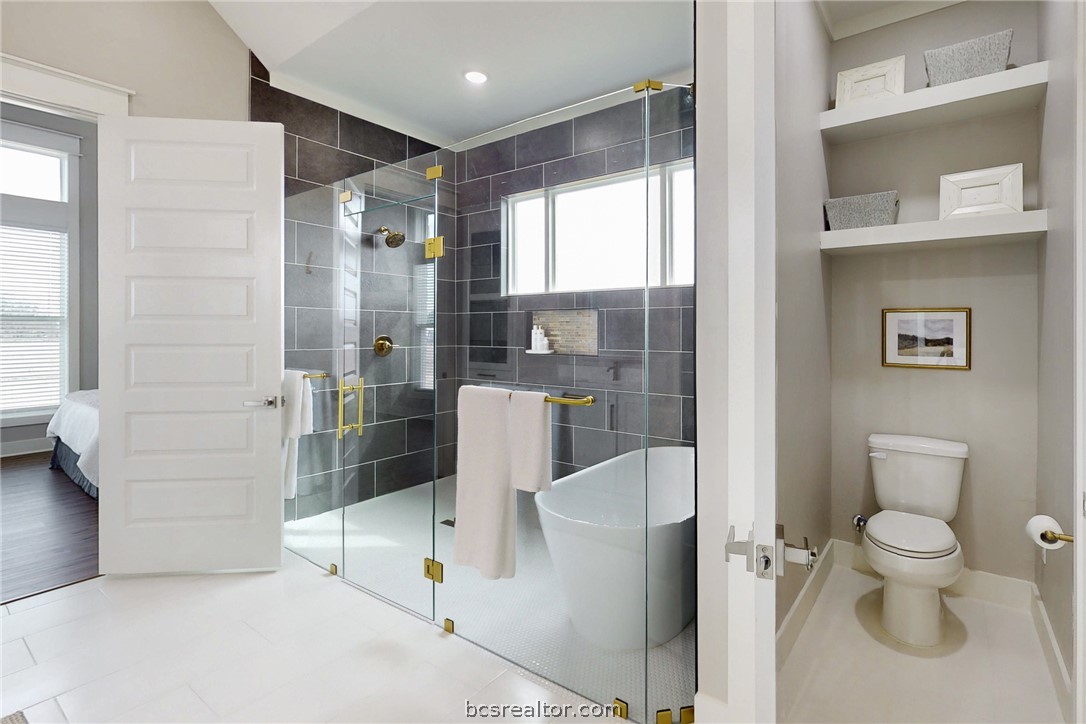13504 Hudson Farms Road Hearne, TX 77859 - Photo 11 of 48 This shower will quickly be one of your favorite features of the house. Splash all you want...This shower is so big you could bathe the whole Fam Damily at the same time :-) Tub is on one end of the enclosed glass, and the shower is on the other end. The builder gets a Gold Star for this design!