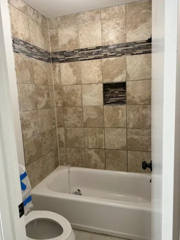 a bathroom with a shower and a bathtub