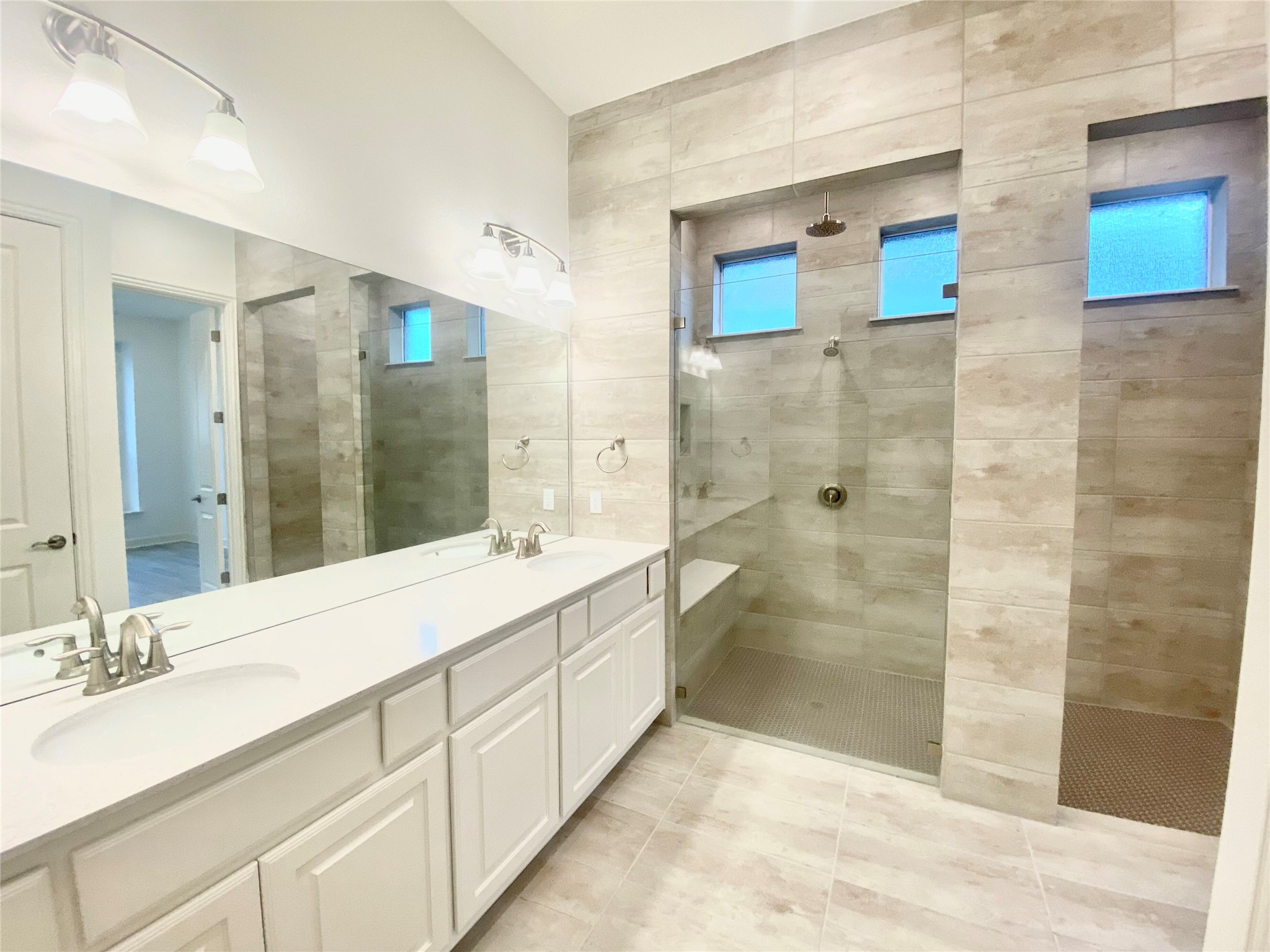 6009 Cimarron Ridge Lane Austin, TX 78738 - Photo 10 of 21 a bathroom with a double vanity sink mirror and shower