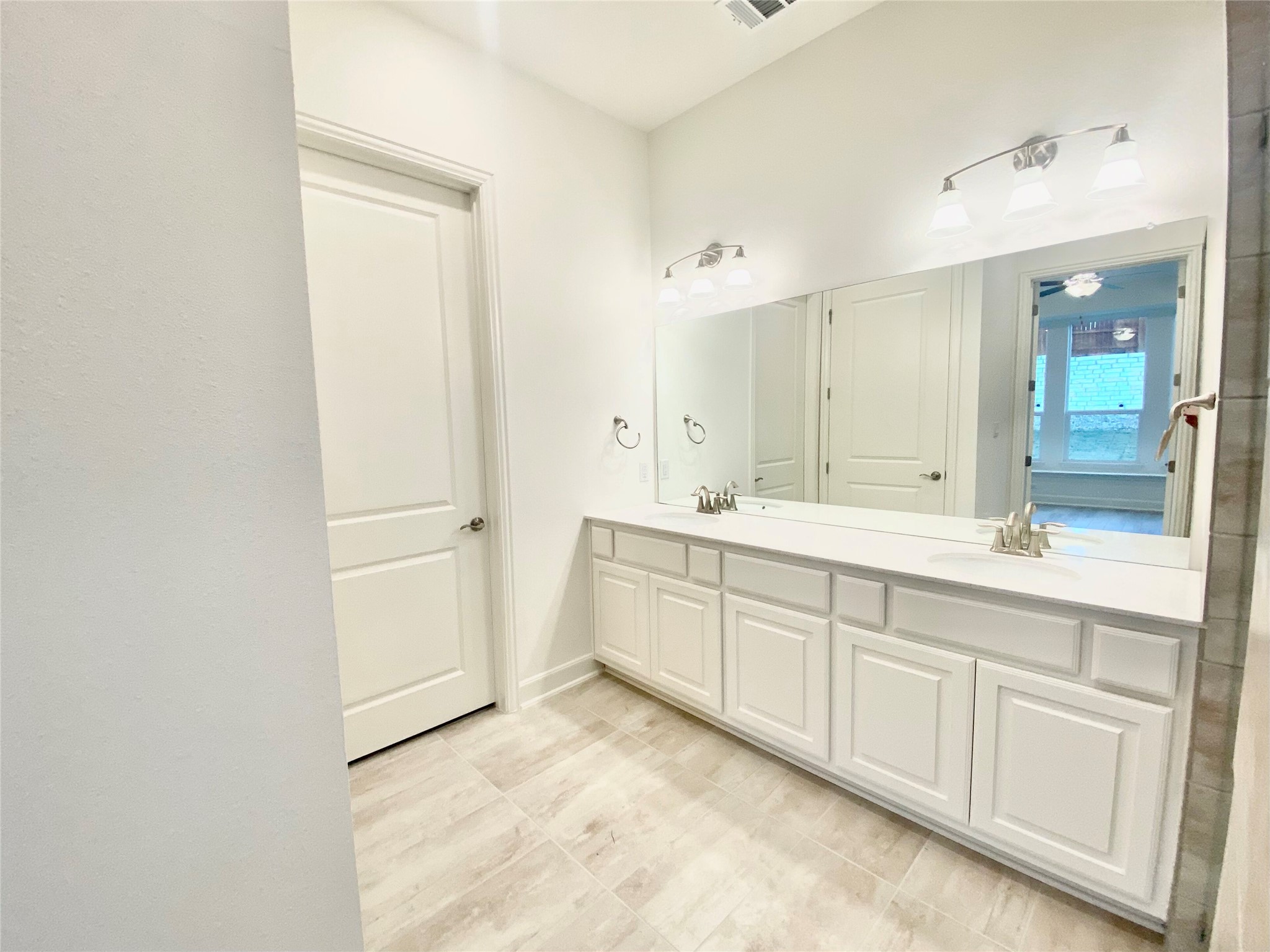 6009 Cimarron Ridge Lane Austin, TX 78738 - Photo 11 of 21 a spacious bathroom with a shower sink and mirror