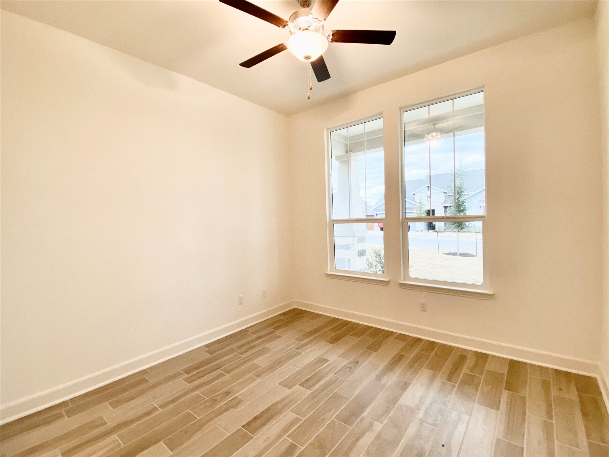 6009 Cimarron Ridge Lane Austin, TX 78738 - Photo 12 of 21 a view of an empty room with wooden floor and a window