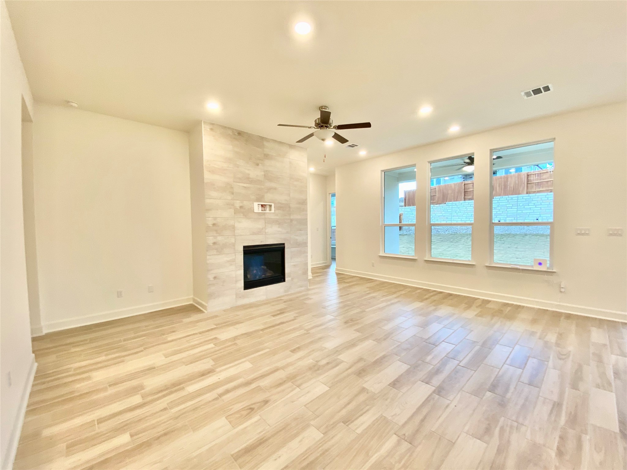 6009 Cimarron Ridge Lane Austin, TX 78738 - Photo 3 of 21 a view of an empty room with a fireplace and a window