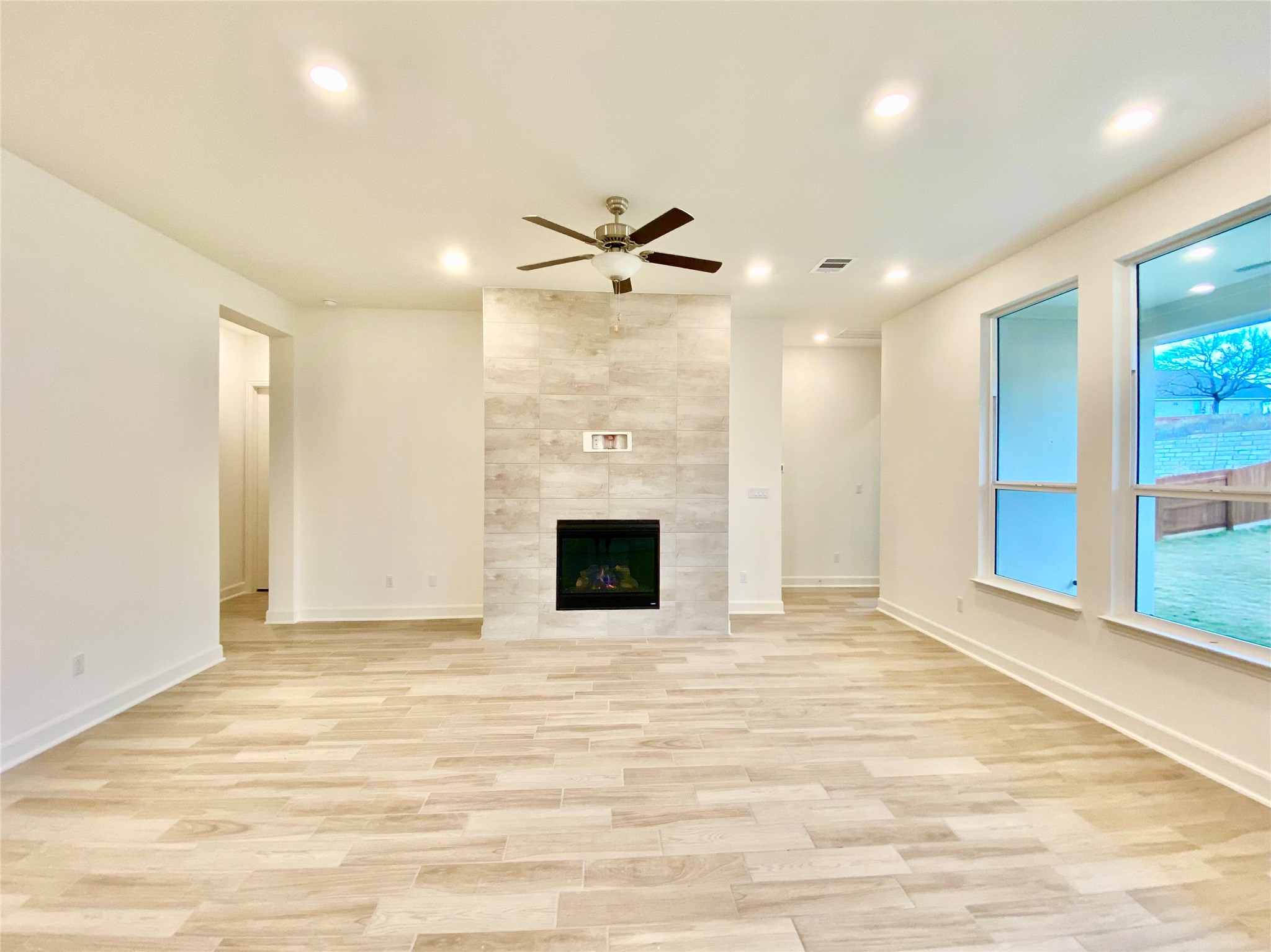6009 Cimarron Ridge Lane Austin, TX 78738 - Photo 4 of 21 an empty room with fireplace and fan