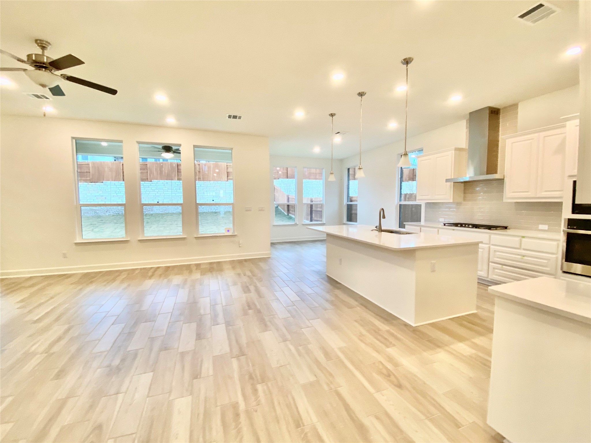 6009 Cimarron Ridge Lane Austin, TX 78738 - Photo 19 of 21 a large kitchen with stainless steel appliances kitchen island granite countertop a large cabinets a sink and a stove