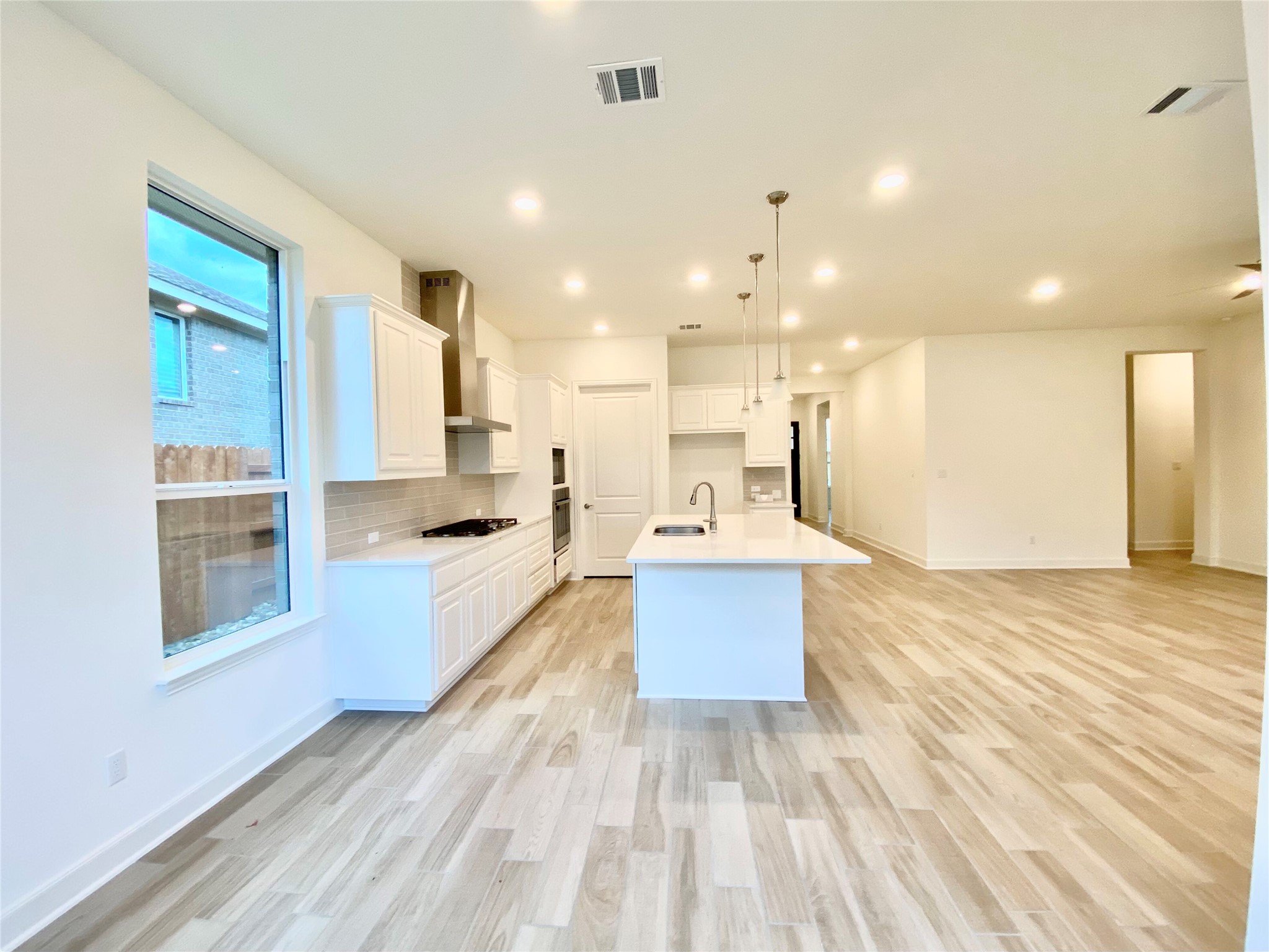 6009 Cimarron Ridge Lane Austin, TX 78738 - Photo 20 of 21 a large kitchen with stainless steel appliances kitchen island a large counter top and a wooden floors
