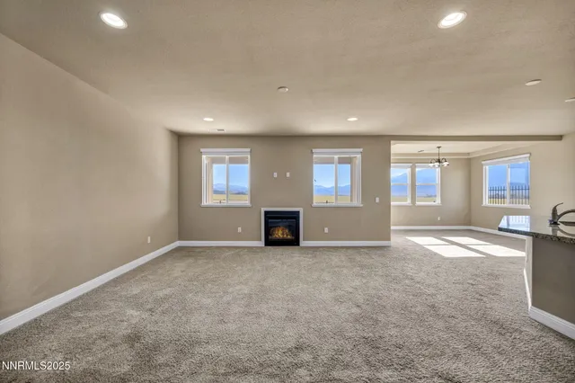 an empty room with fireplace and windows