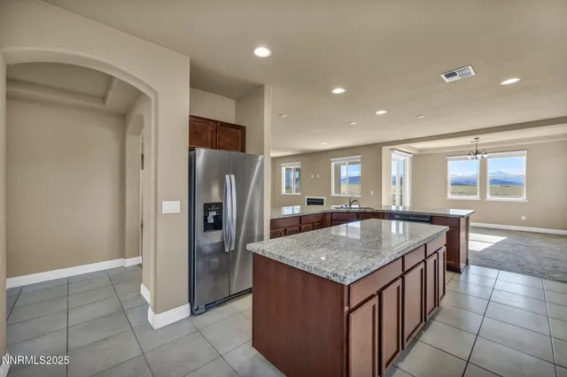a kitchen with stainless steel appliances granite countertop a refrigerator and a sink