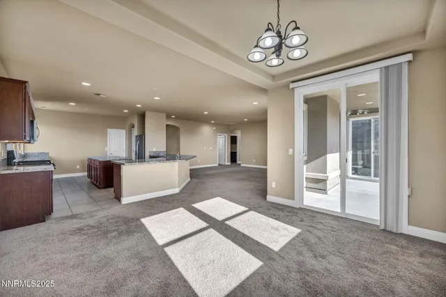 a view of a big room with chandelier kitchen view and a chandelier