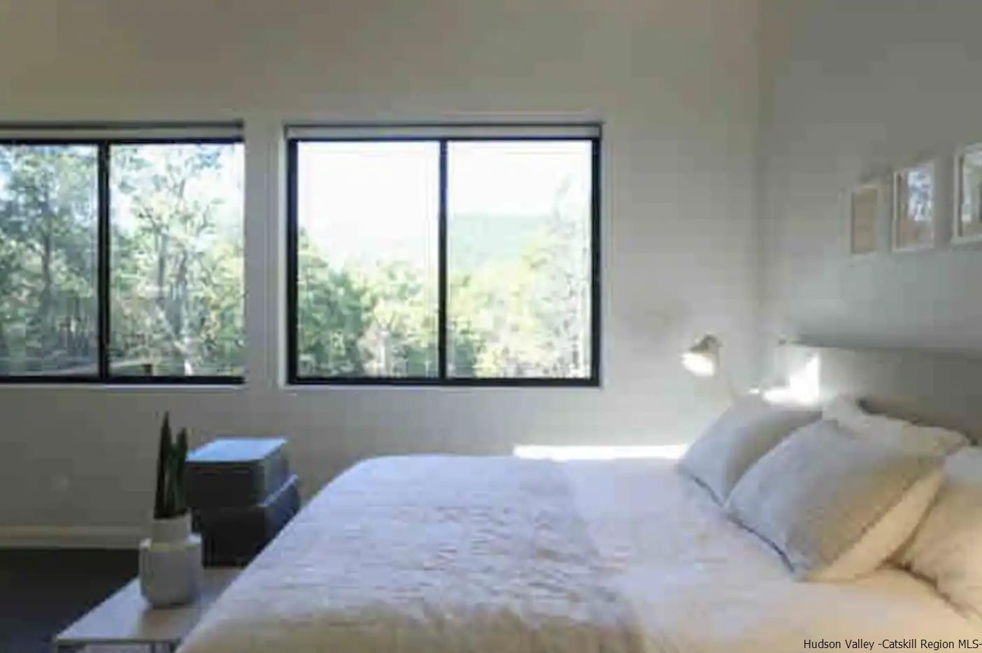 49 Aster Road Kerhonkson, NY 12446 - Photo 13 of 34 a bedroom with a bed and a large window