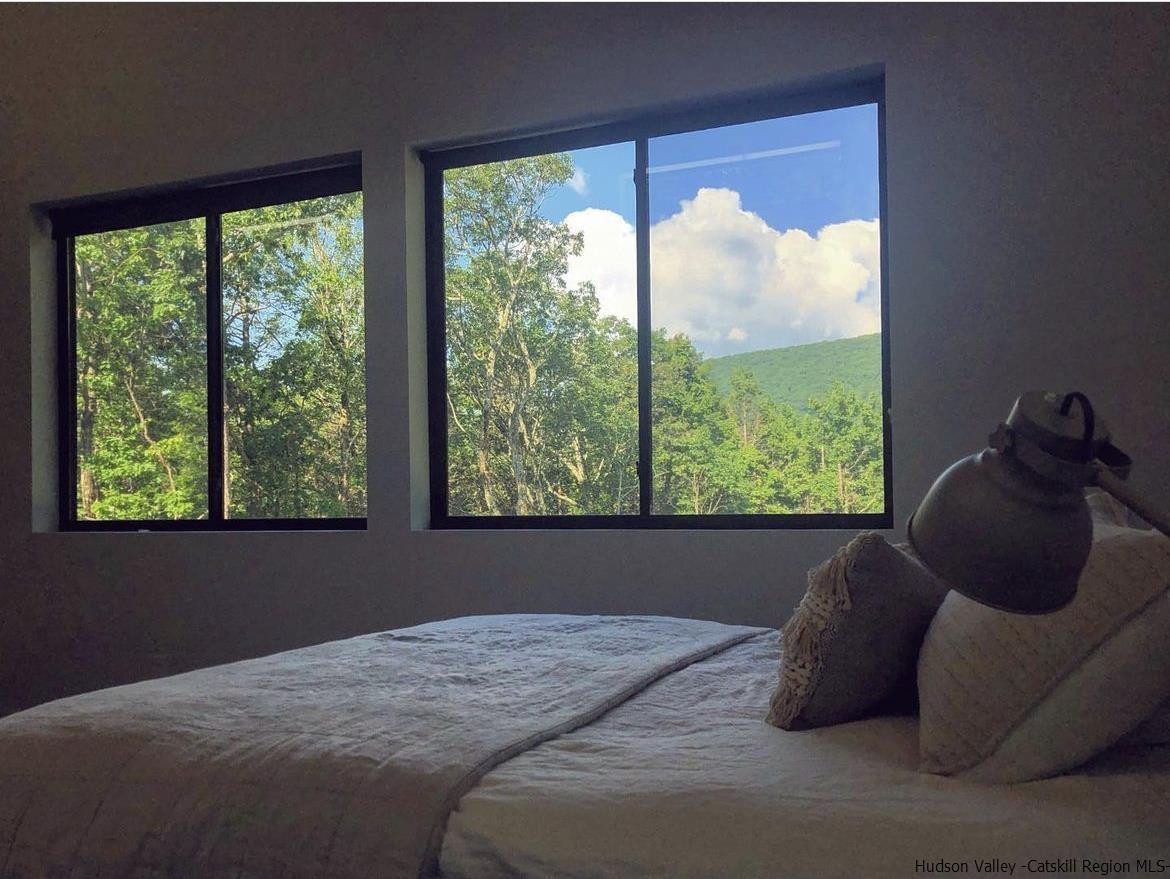 49 Aster Road Kerhonkson, NY 12446 - Photo 26 of 34 a bed sitting in a bedroom next to a window