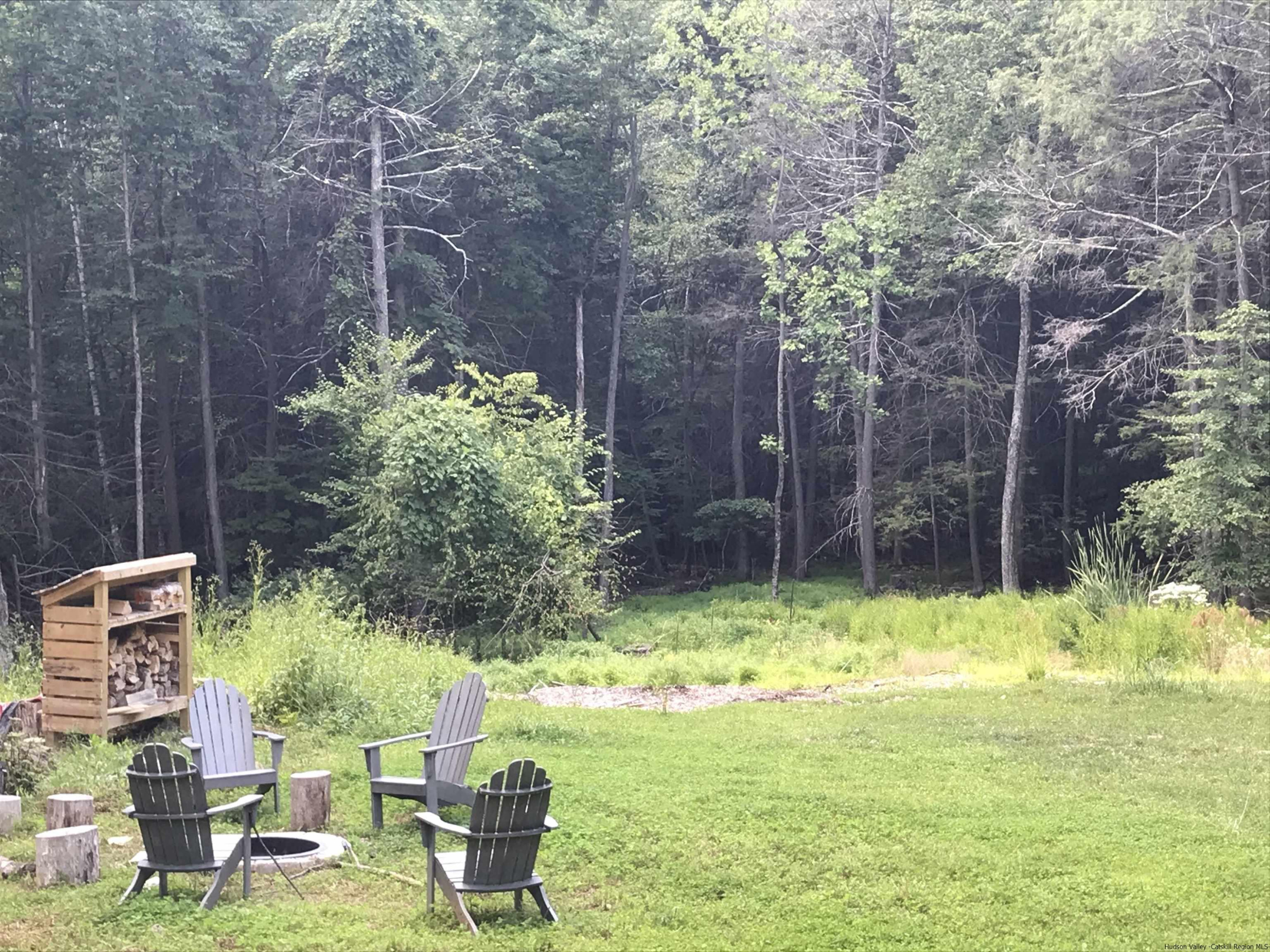 49 Aster Road Kerhonkson, NY 12446 - Photo 32 of 34 a backyard of a house with yard and outdoor seating