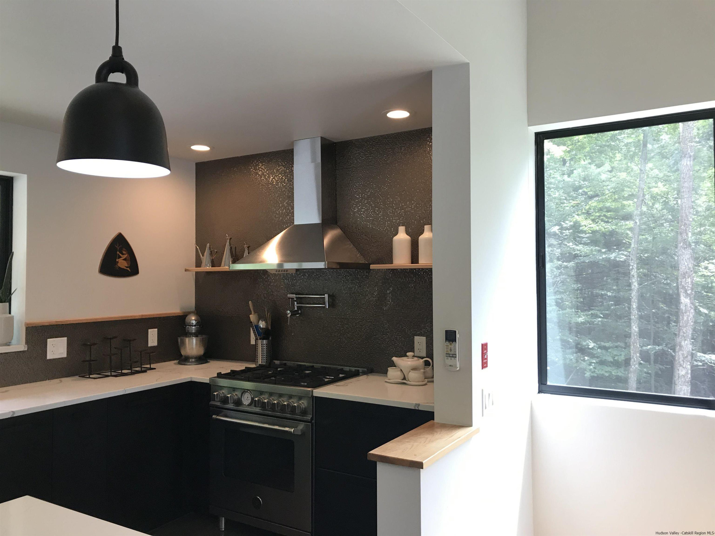 49 Aster Road Kerhonkson, NY 12446 - Photo 7 of 34 a kitchen with a stove and a cabinet
