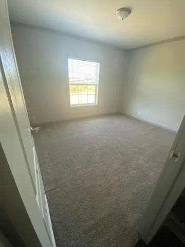 a view of an empty room and a window