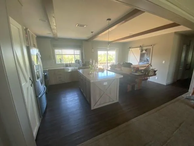 a kitchen with sink refrigerator and window
