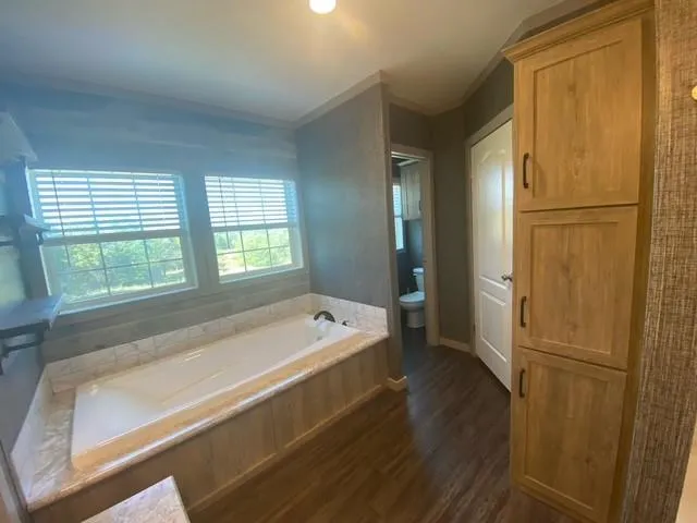 a bathroom with a tub shower and sink