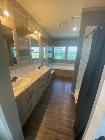 a bathroom with a large tub and sink