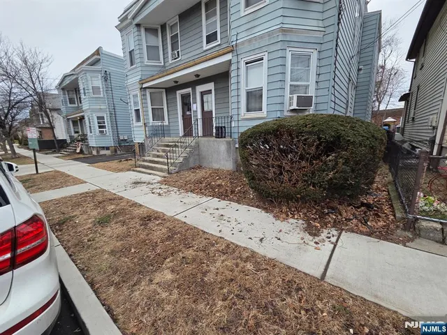 a view of a brick house with many windows