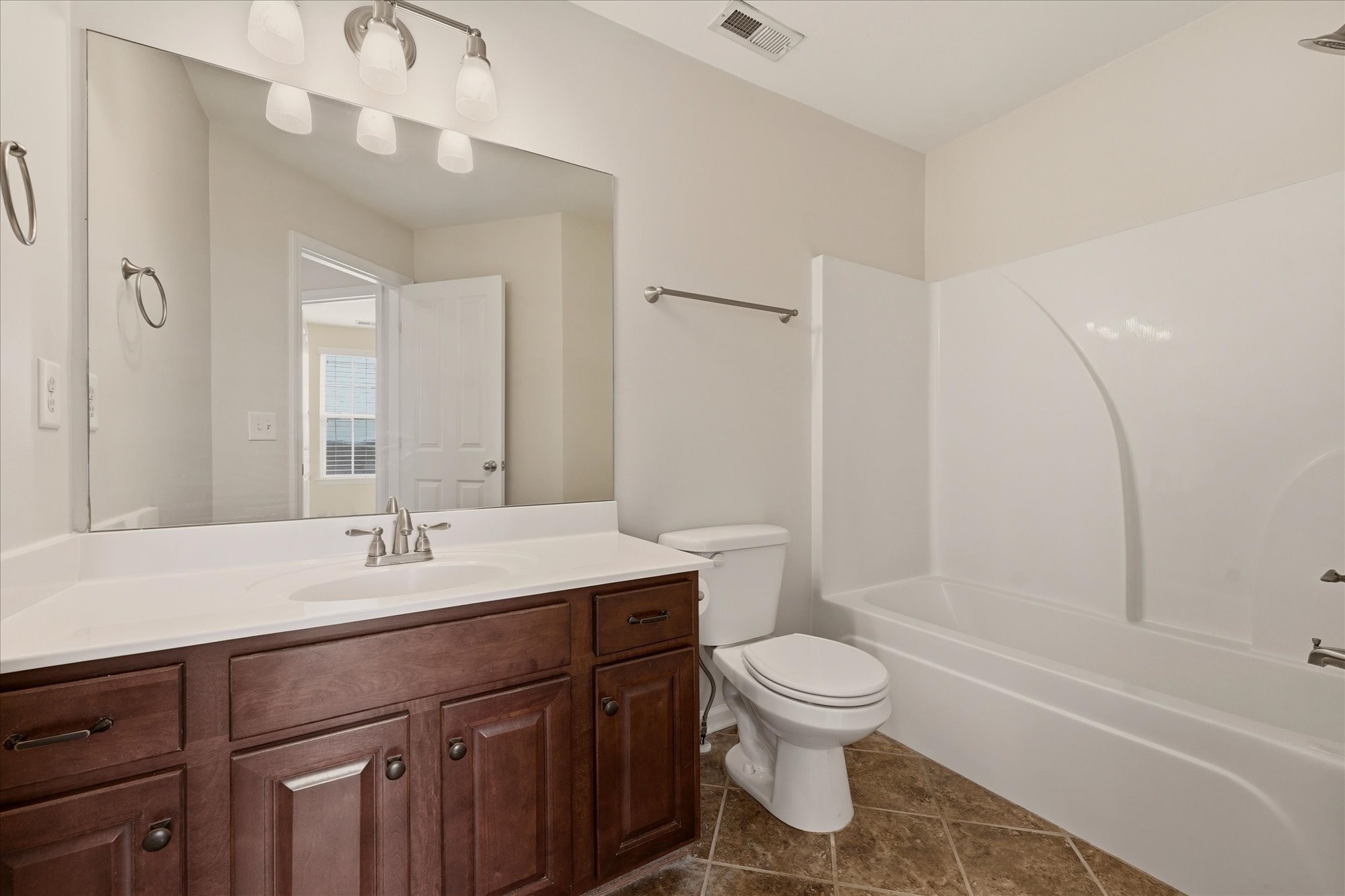 2050 Hemlock Drive Spring Hill, TN 37174 - Photo 22 of 48 a bathroom with a sink toilet a tub and a mirror