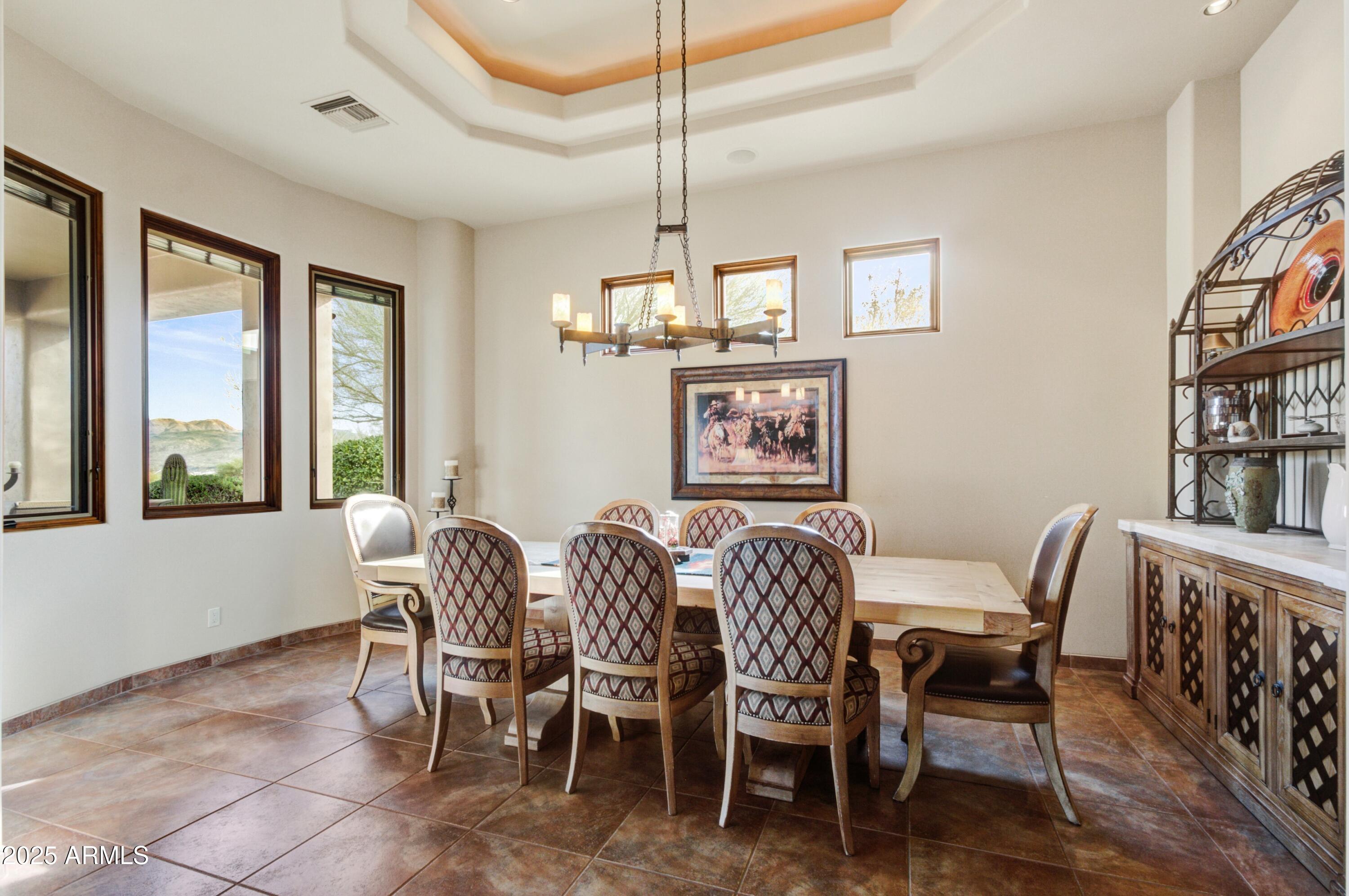 28013 Desierto Drive Rio Verde, AZ 85263 - Photo 11 of 33 a dining room with furniture a chandelier and wooden floor