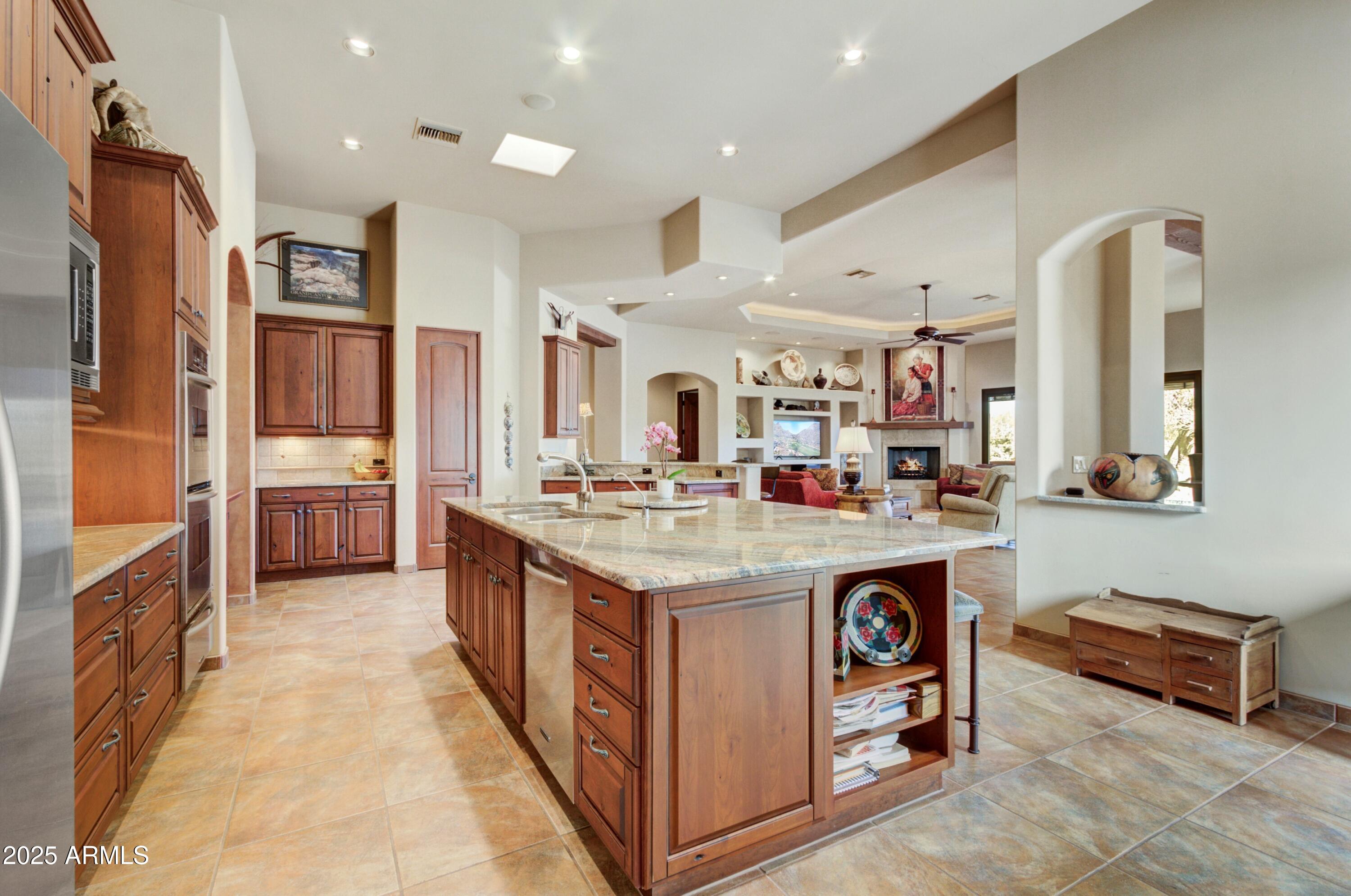 28013 Desierto Drive Rio Verde, AZ 85263 - Photo 10 of 33 a kitchen with kitchen island a sink stove and refrigerator