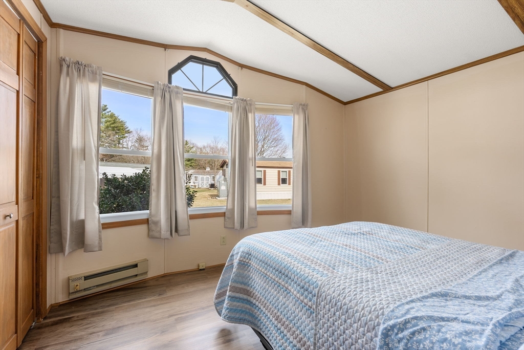 231 Park Circle Sturbridge, MA 01566 - Photo 20 of 32 a bedroom with a bed and a large window with the outer view
