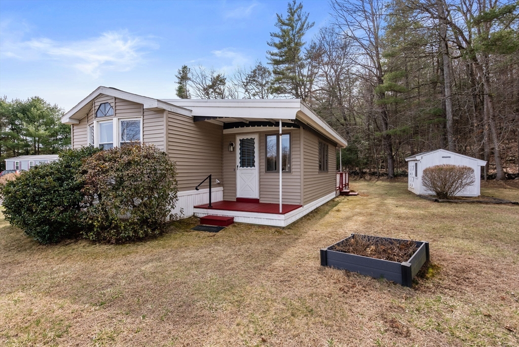 231 Park Circle Sturbridge, MA 01566 - Photo 5 of 32 a view of a house with a yard and wooden fence