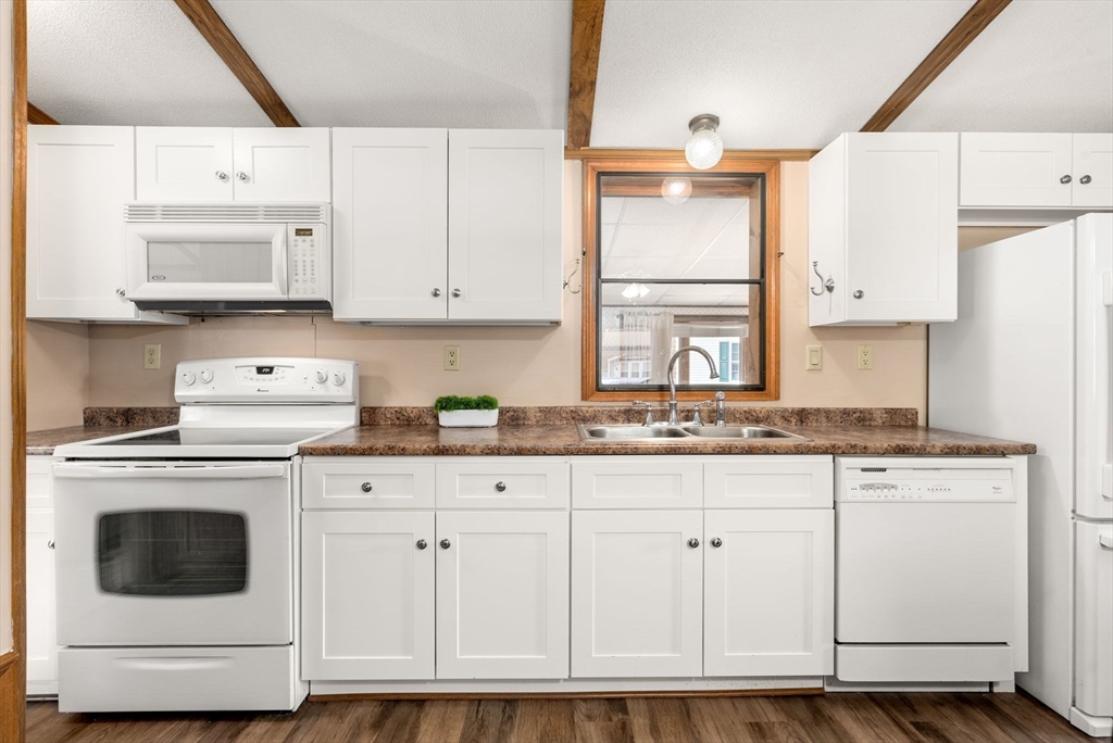 231 Park Circle Sturbridge, MA 01566 - Photo 7 of 32 a kitchen with granite countertop white cabinets and white appliances