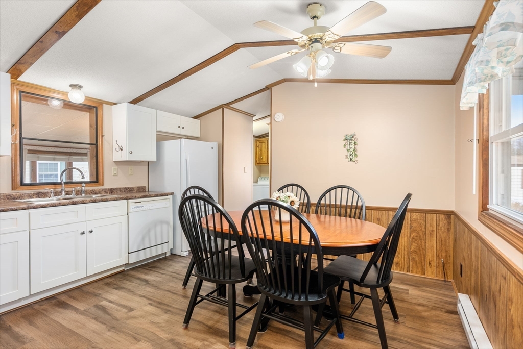 231 Park Circle Sturbridge, MA 01566 - Photo 10 of 32 a dining room with furniture a chandelier and wooden floor