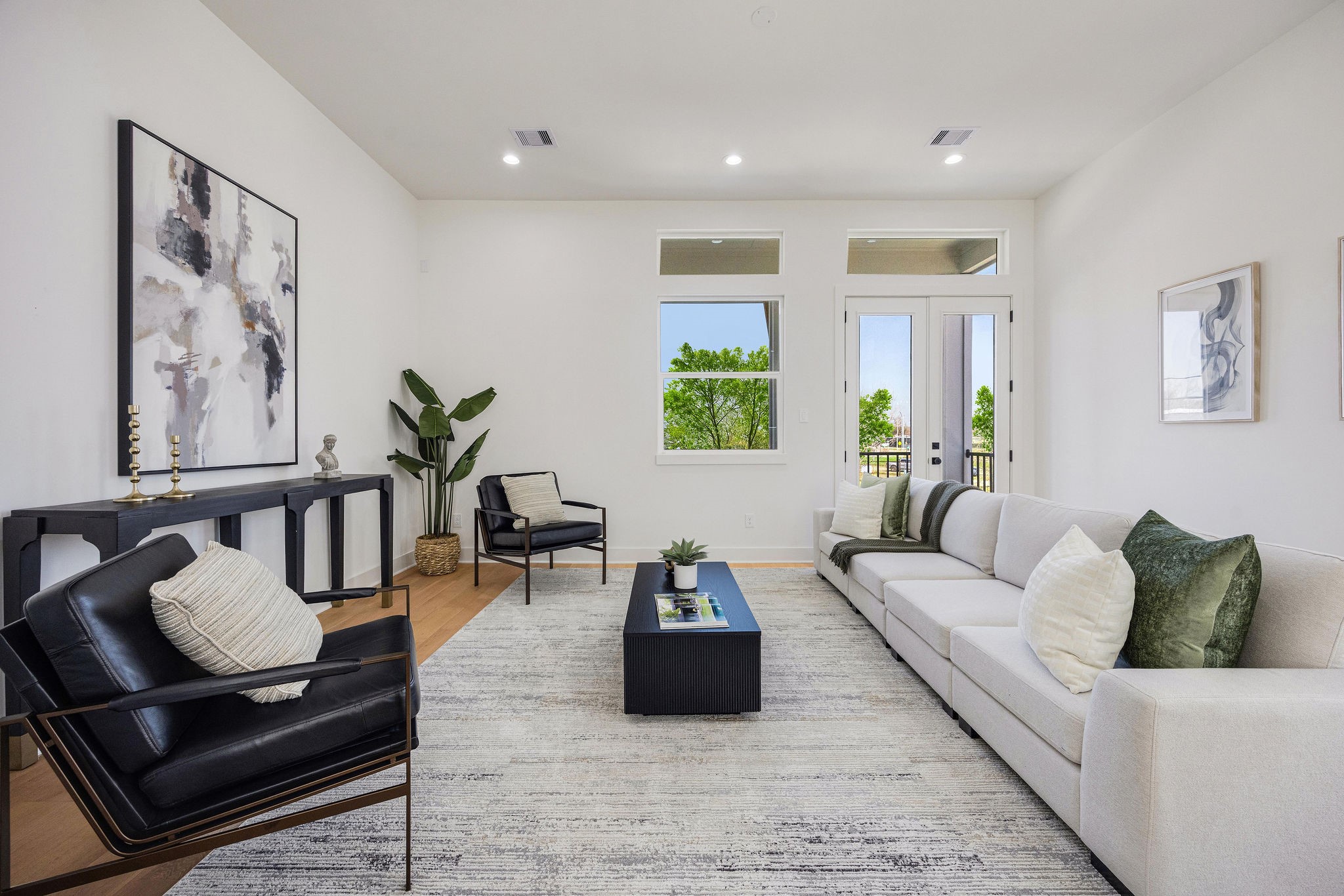 303 Marcella Street, Unit P Houston, TX 77091 - Photo 6 of 26 This bright and modern living room. Large windows offer natural light and a view of greenery, while a neutral color palette enhances the airy atmosphere.