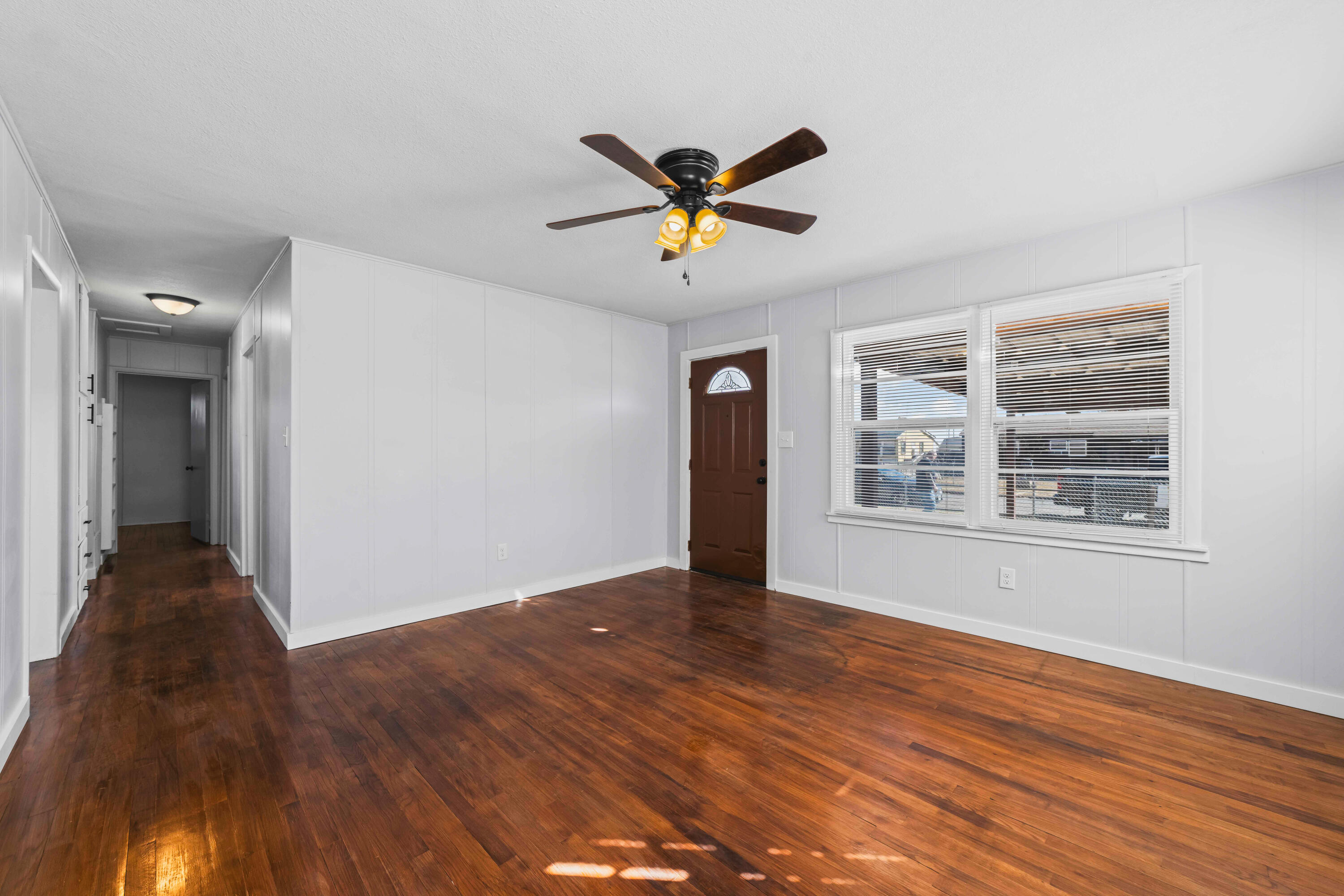 3017 East 3rd Street Lubbock, TX 79403 - Photo 2 of 15 a view of an empty room with window and wooden floor