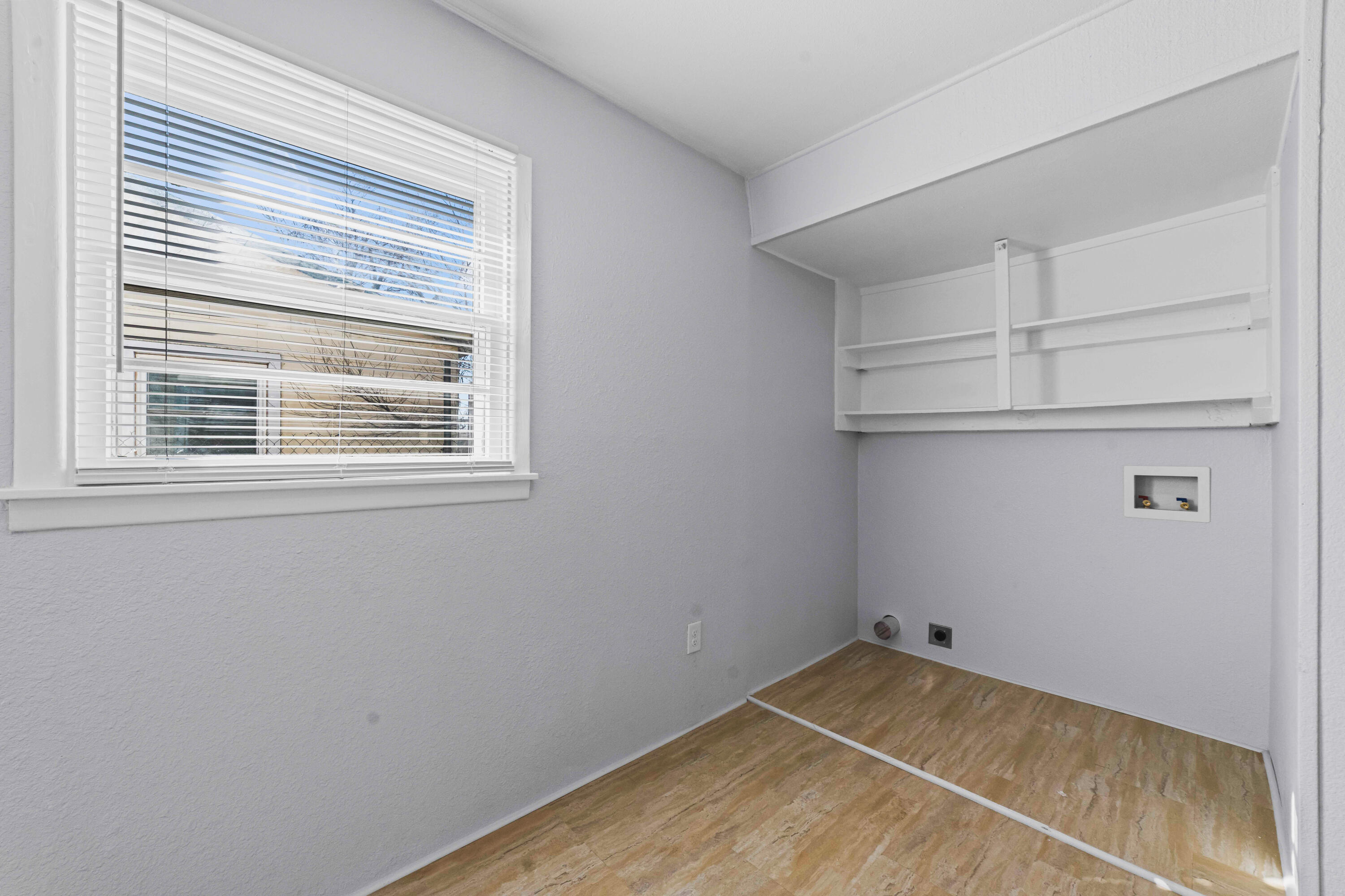 3017 East 3rd Street Lubbock, TX 79403 - Photo 6 of 15 a view of a room with rack on the wall and a window