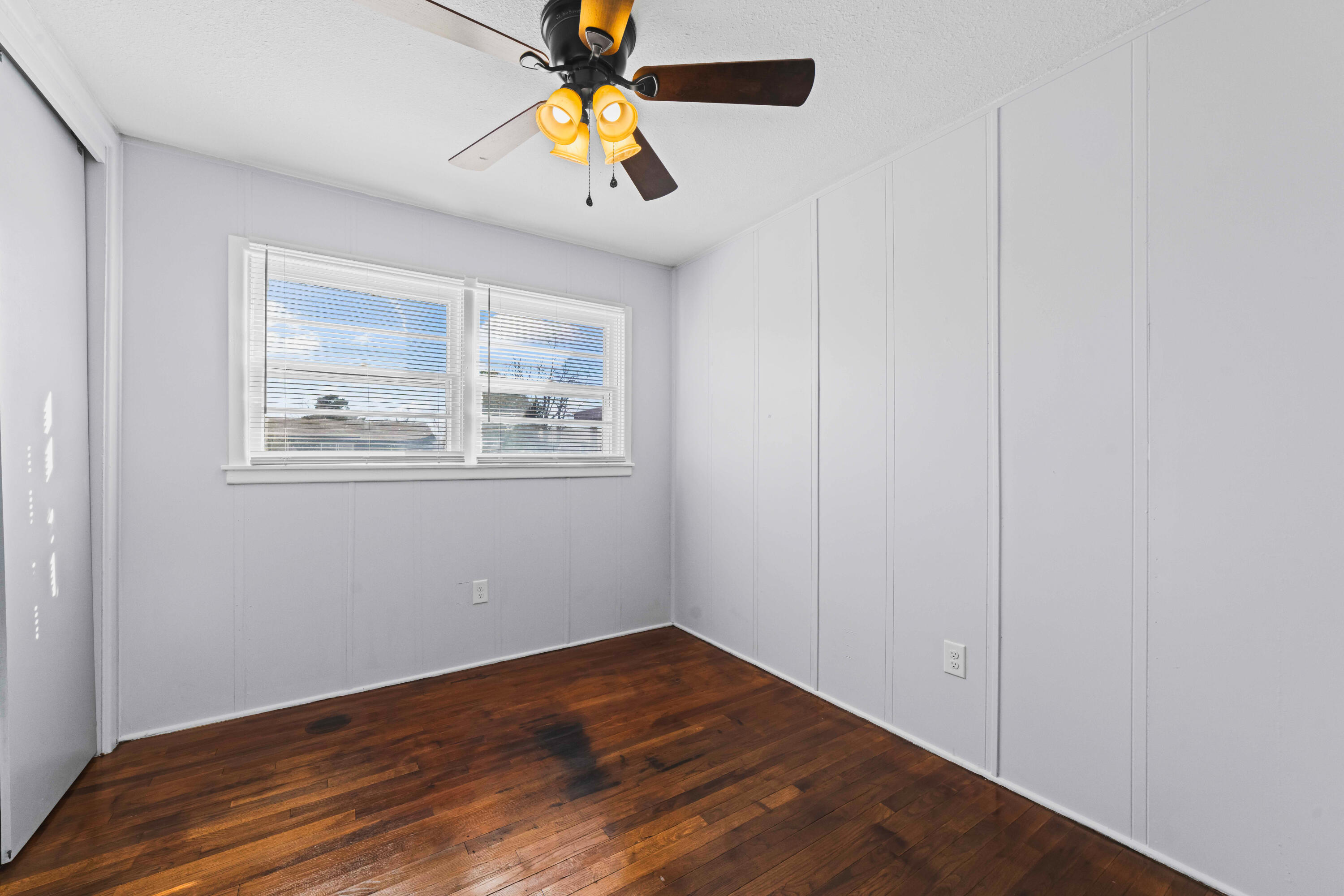 3017 East 3rd Street Lubbock, TX 79403 - Photo 8 of 15 a view of an empty room with window and wooden floor
