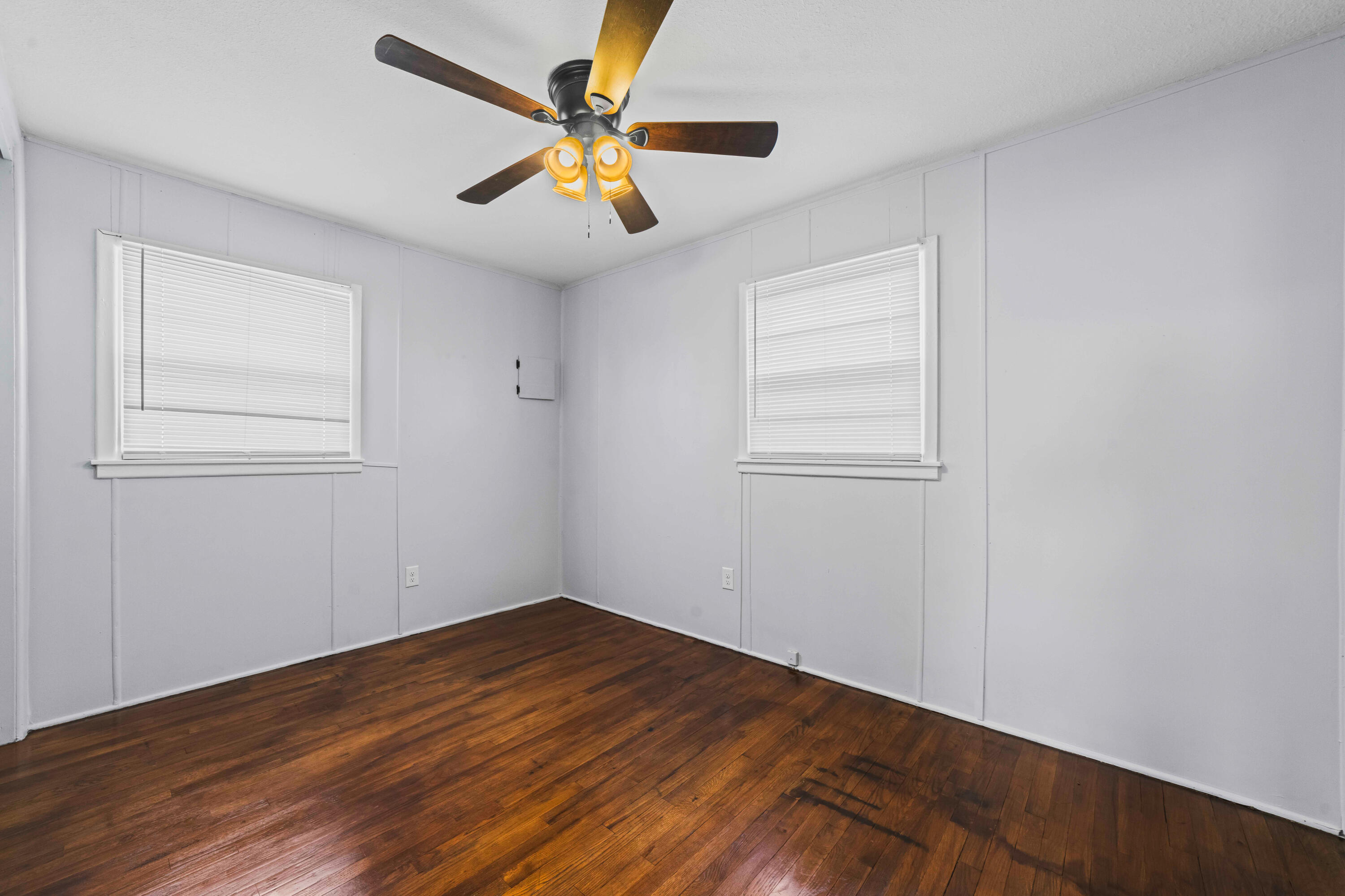 3017 East 3rd Street Lubbock, TX 79403 - Photo 9 of 15 an empty room with wooden floor and windows