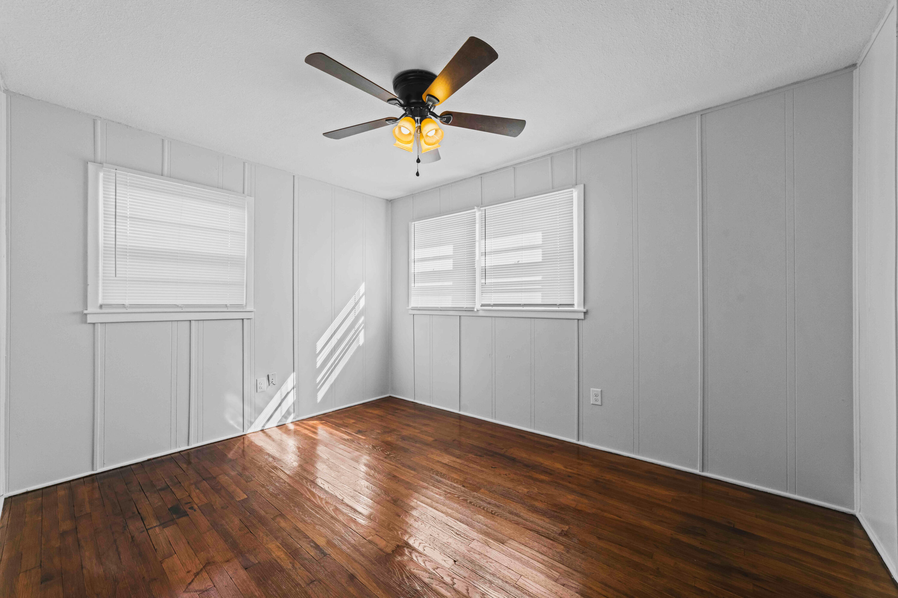 3017 East 3rd Street Lubbock, TX 79403 - Photo 10 of 15 a view of empty room with wooden floor and fan