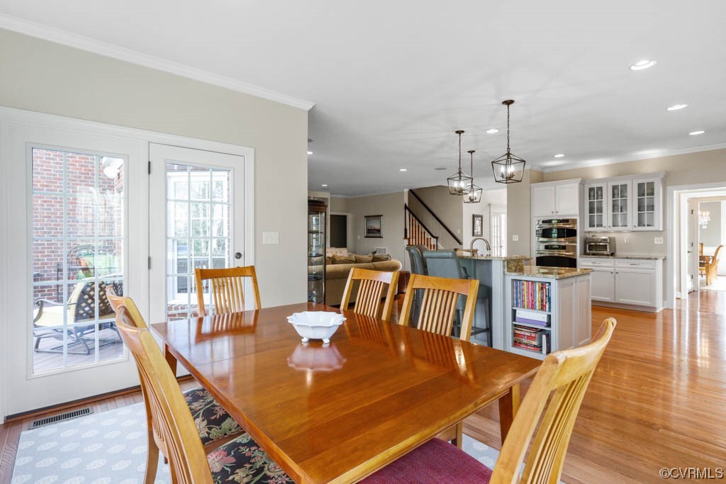 4318 Elmstone Road Midlothian, VA 23113 - Photo 17 of 47 a dining room with wooden floor and large windows
