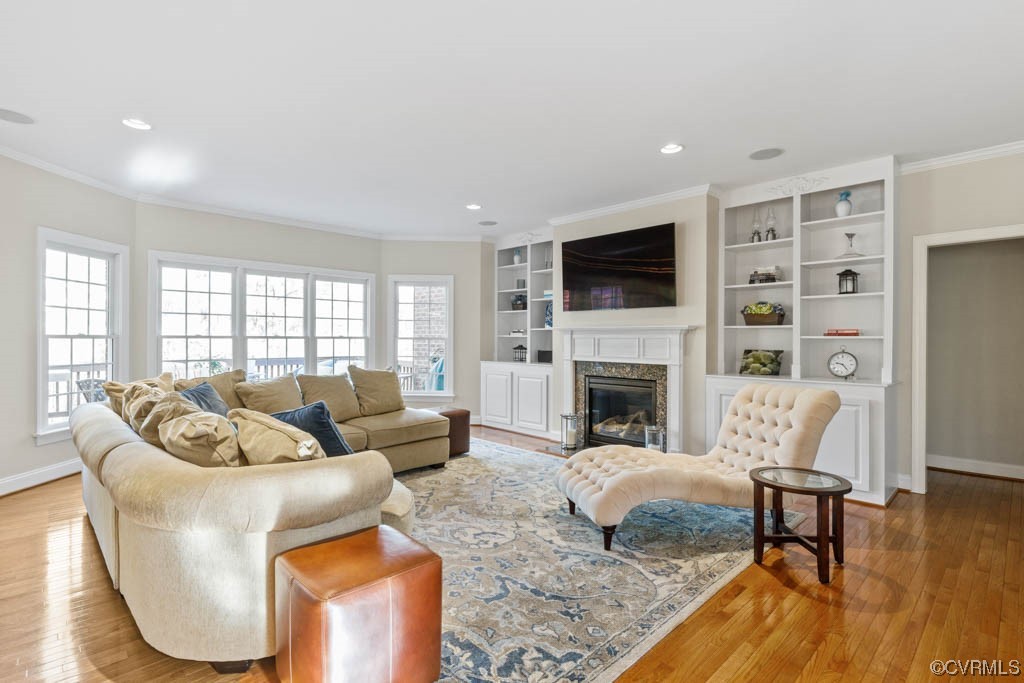 4318 Elmstone Road Midlothian, VA 23113 - Photo 18 of 47 a living room with furniture a fireplace a flat screen tv and a large window