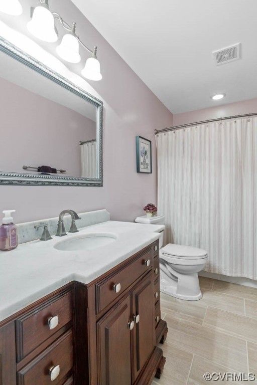 4318 Elmstone Road Midlothian, VA 23113 - Photo 44 of 47 a bathroom with a granite countertop sink a toilet and a mirror