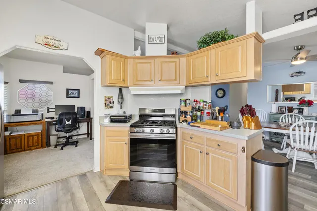 a kitchen with stainless steel appliances granite countertop a stove and cabinets